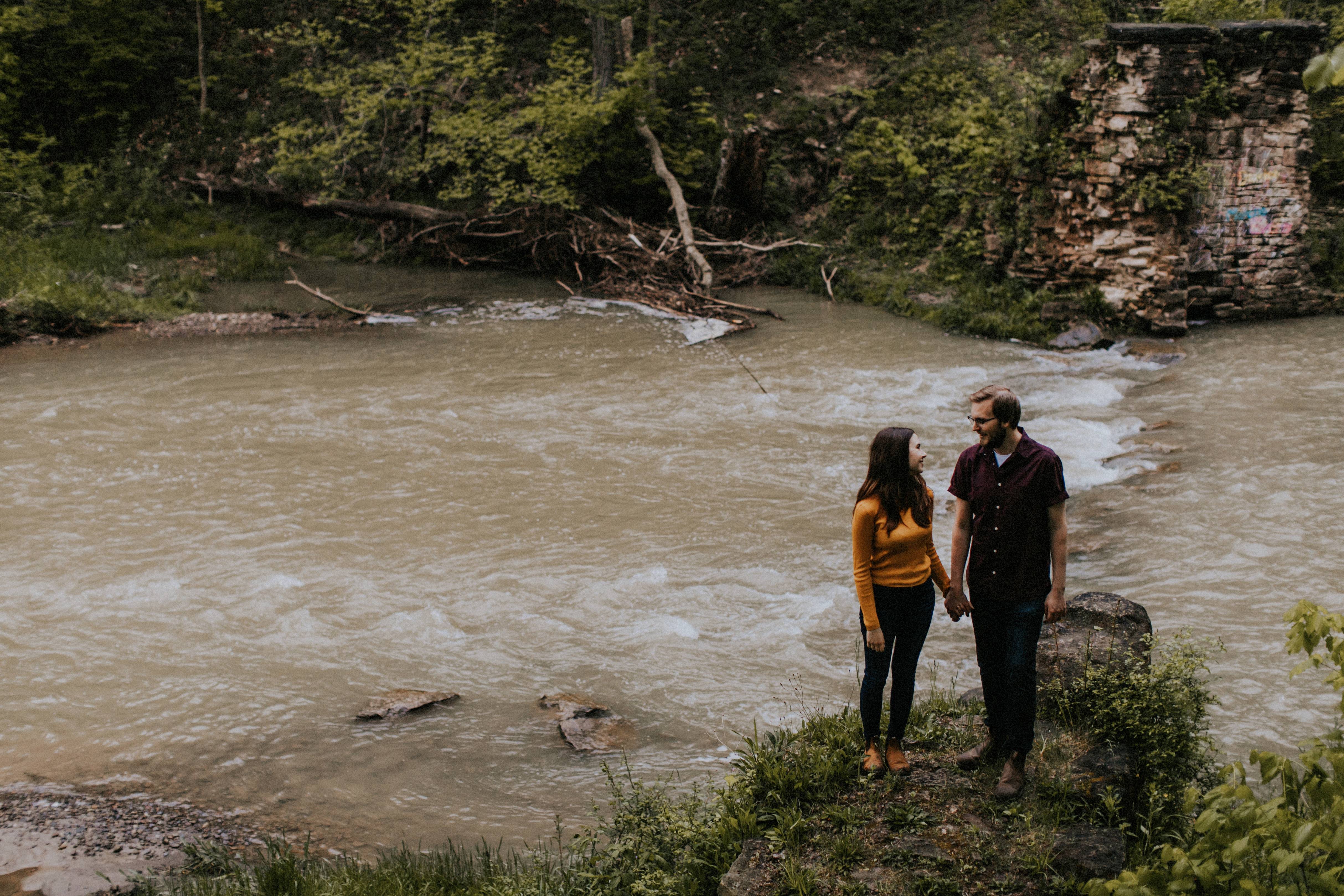 couple standing by stream