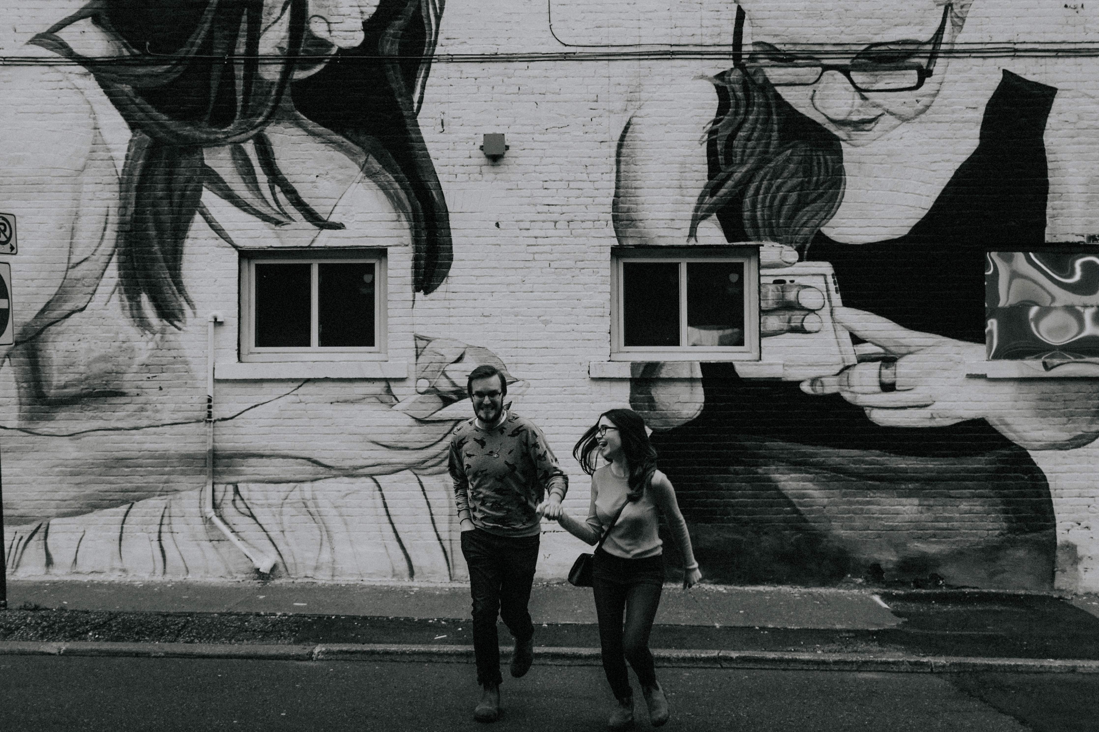 couple running by graffiti