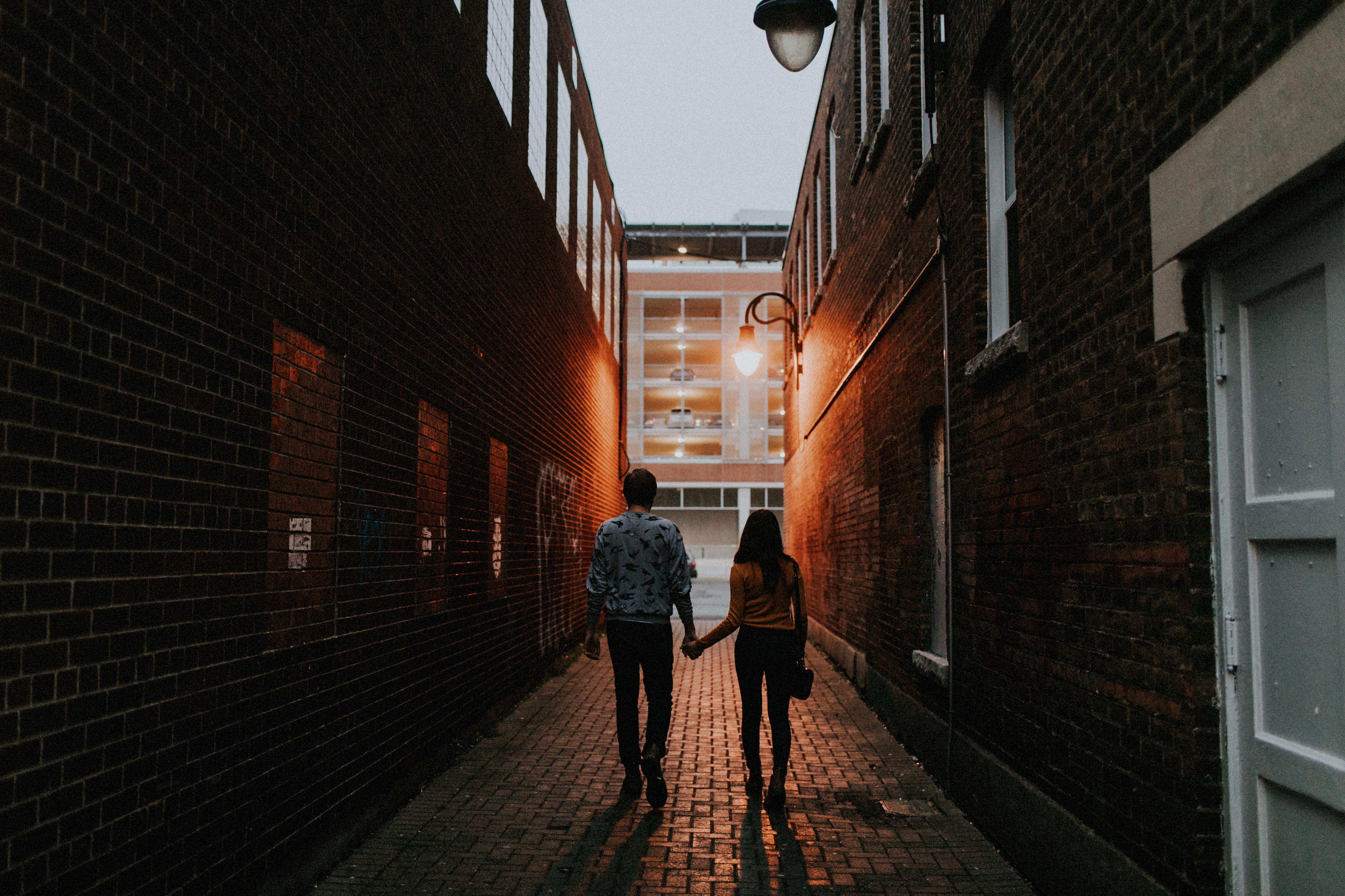 couple walking in alley way at night