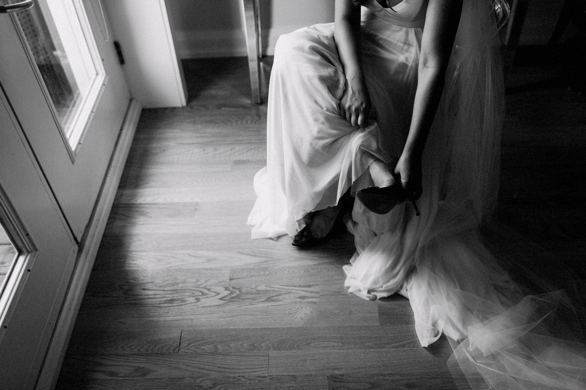bride puts her shoes on