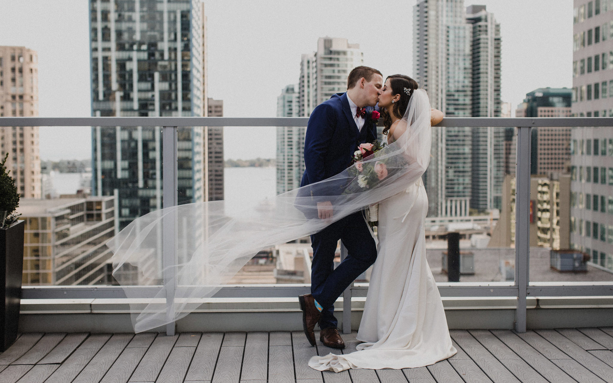 kiss on rooftop at downtown toronto wedding