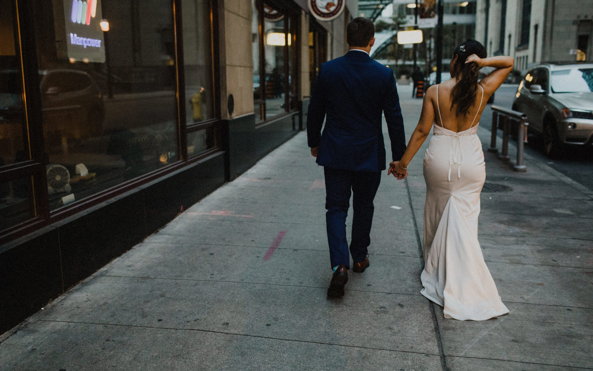 bride and groom walking downtown