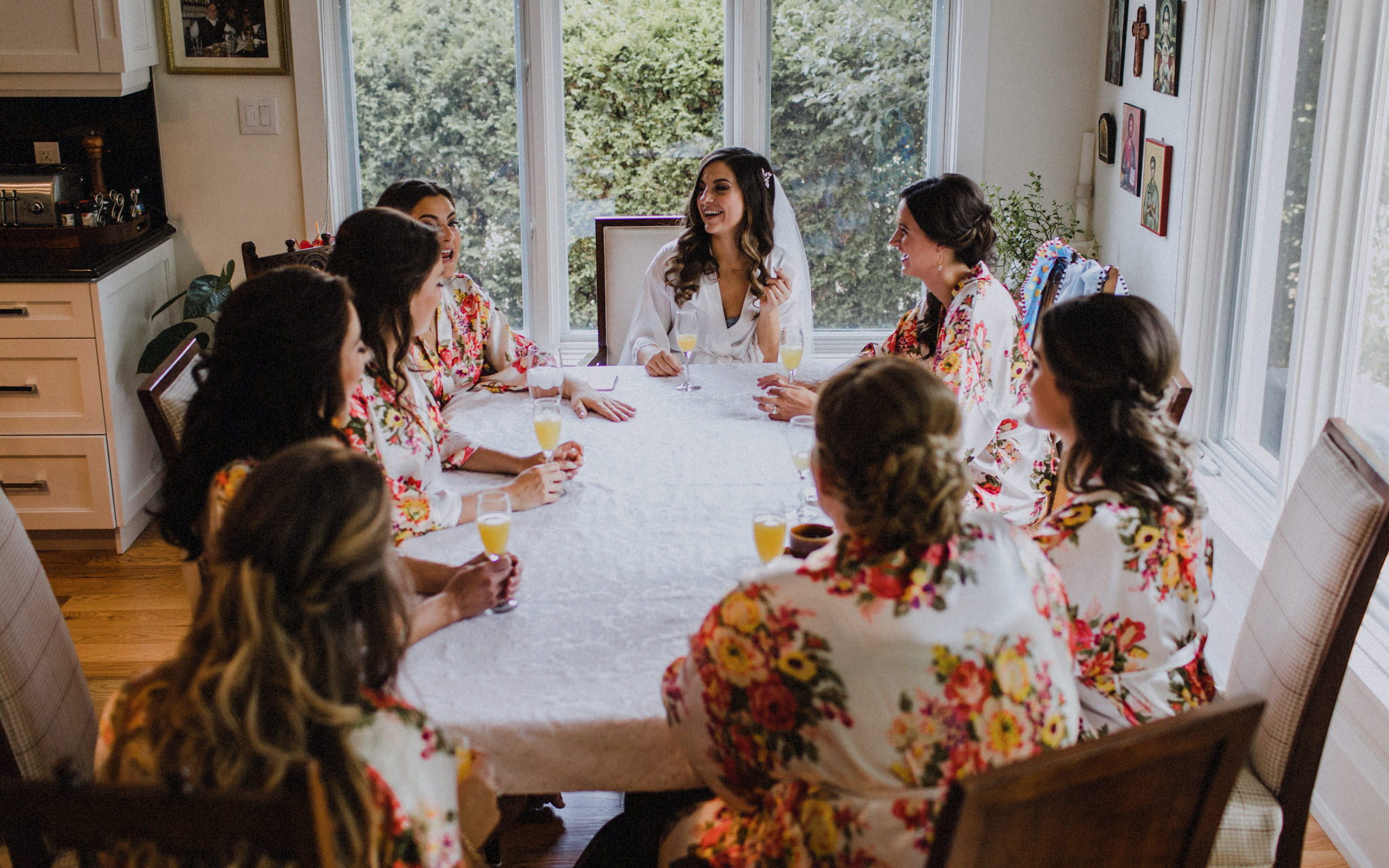 bride and bridesmaids share a mimosa