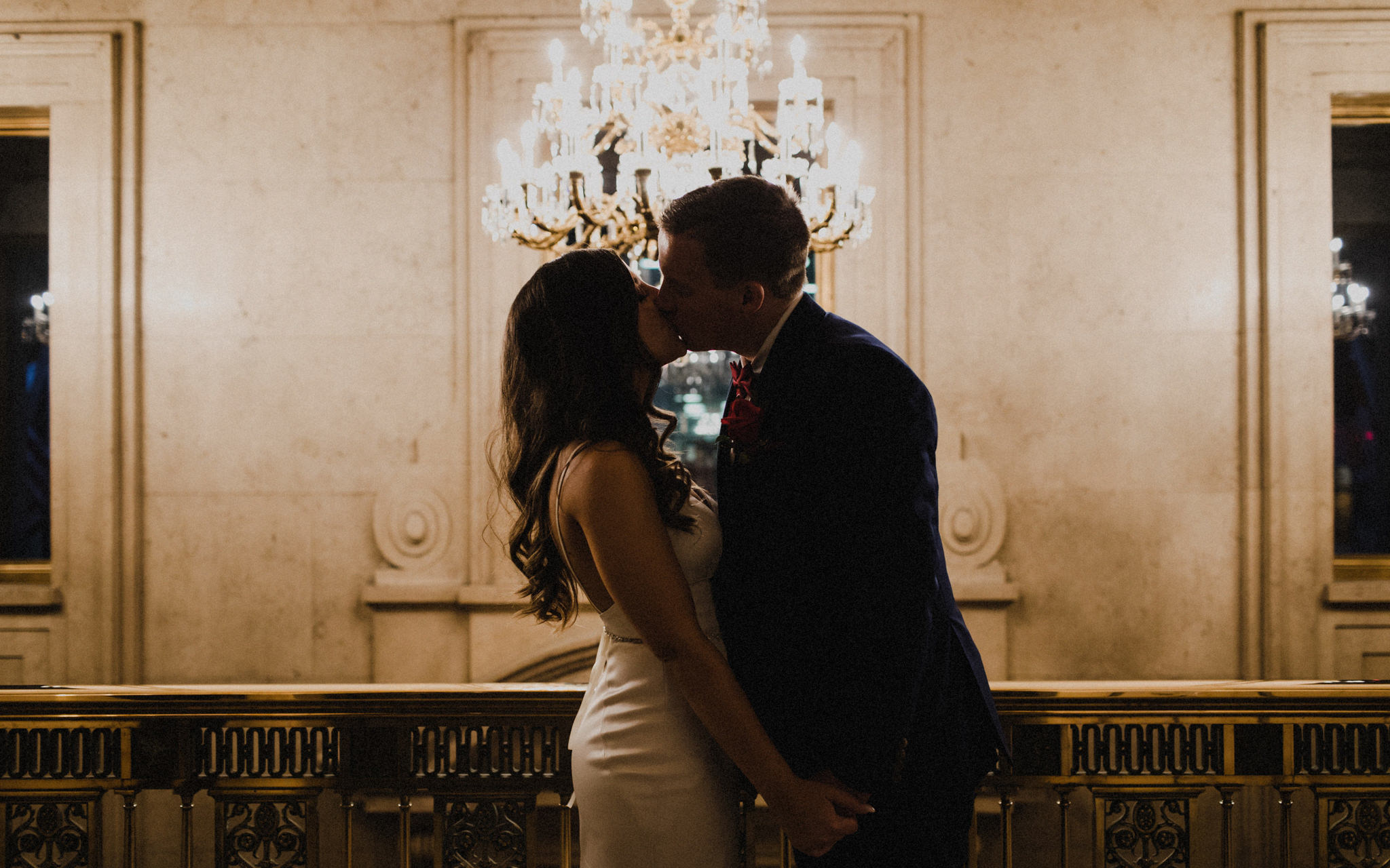 couple kissing by chandelier