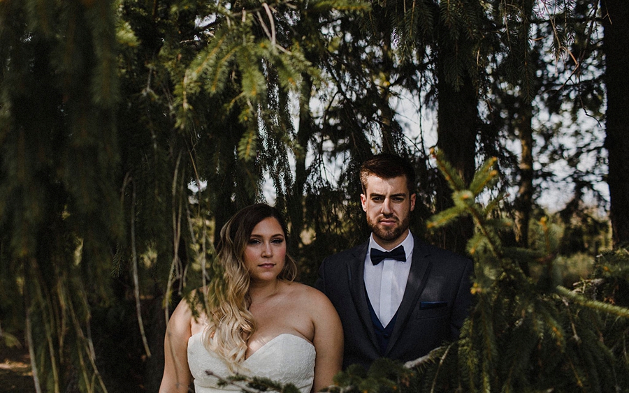 bride groom in pine trees