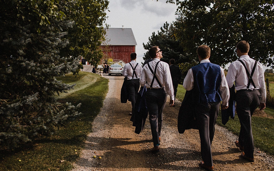 groomsmen walk at farm