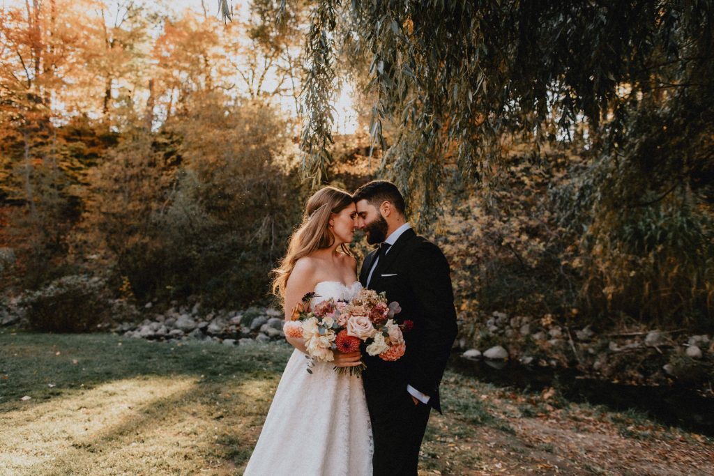 Bride and groom touch foreheads under backlit willow tree - Autumn Micro Wedding at Berkeley Fieldhouse