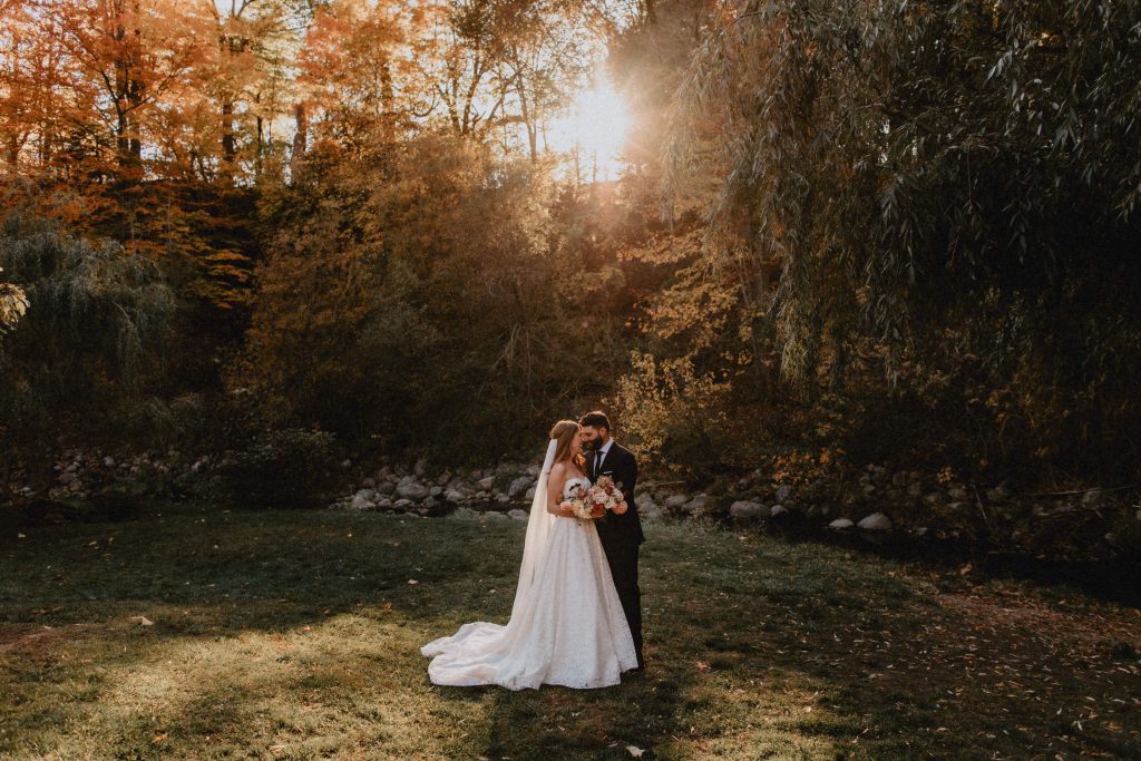 Bride and groom kiss under backlit willow tree in Edwards Gardens - Autumn Micro Wedding at Berkeley Fieldhouse