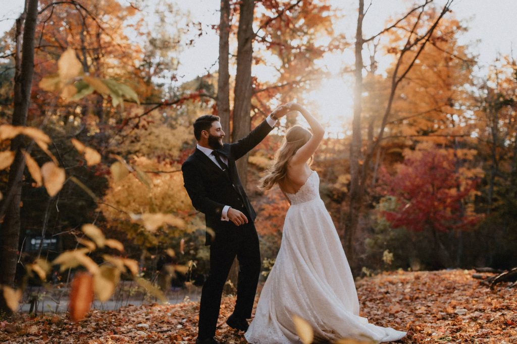 Groom Twirls bride through the fall leaves - Autumn Micro Wedding at Berkeley Fieldhouse