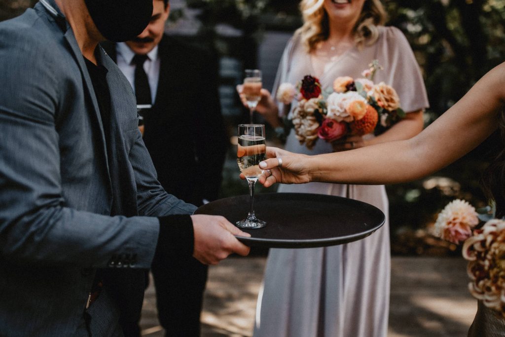 Guest takes champagne - Autumn Micro Wedding at Berkeley Fieldhouse