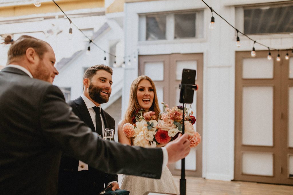 Bride and groom connect with remote guests - Autumn Micro Wedding at Berkeley Fieldhouse