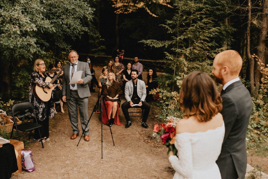 Parents sing to bride and groom during forest ceremony - Huron Natural Area Micro Wedding Kitchener, Ontario