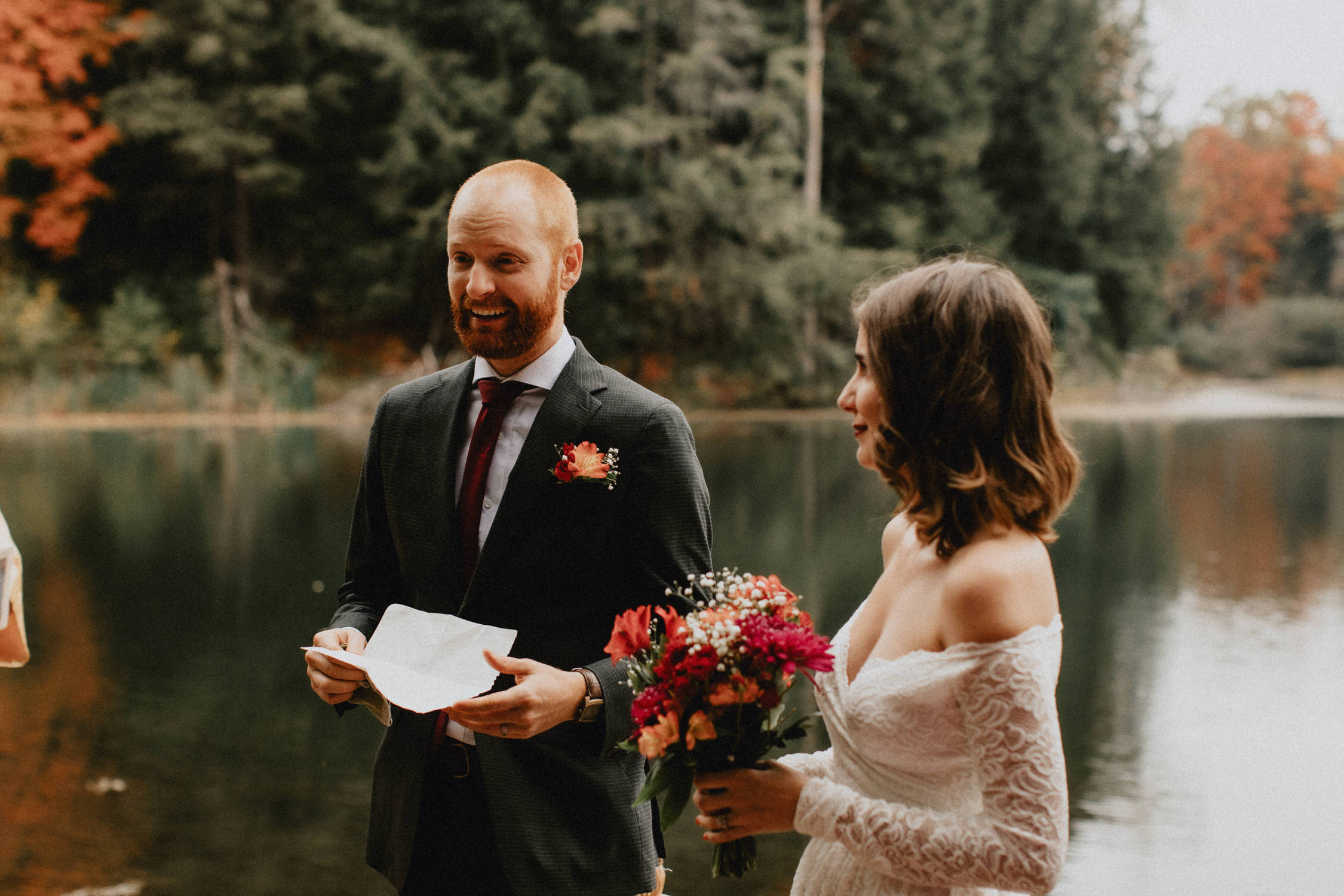 Groom smiles reading vows in the forest - Huron Natural Area Micro Wedding Kitchener, Ontario